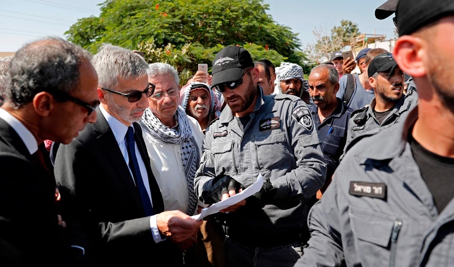European General Consuls of France (2L), Sweden, Belgium, Italy, Ireland, Switzerland, Finland, Denmark and European Union are blocked by Israeli police on their way to visit the Palestinian Bedouin village of Khan al-Ahmar, east of Jerusalem in the occupied West Bank on July 5, 2018. (FP / THOMAS COEX)