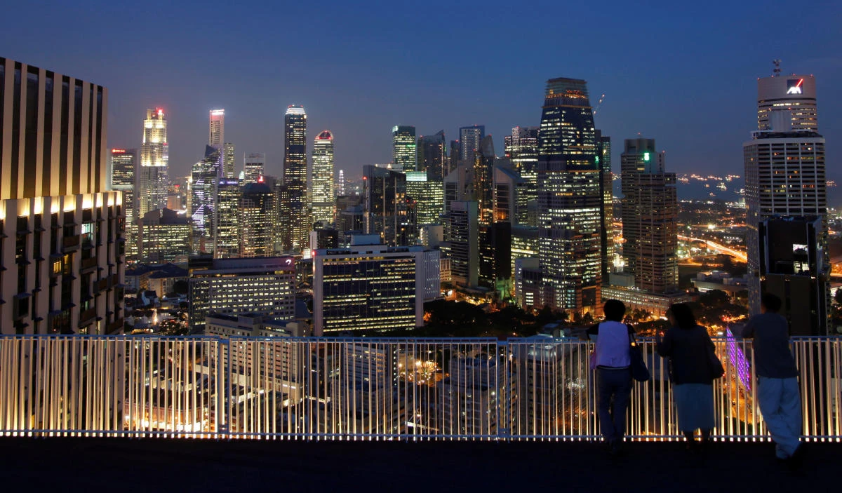 People look at the skyline of the central business district in Singapore. (Reuters)