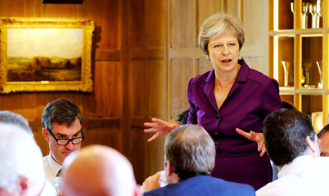 Theresa May wins support from divided UK government on Brexit plan