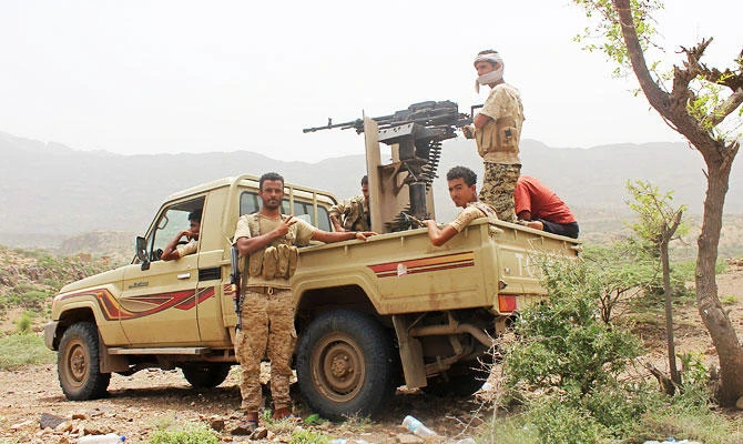 Yemeni pro-government fighters sit at the back of an armed pick-up as Emirati supported forces take over Huthi bases on the frontline of Kirsh between the province of Taez and Lahj, southwestern Yemen, on July 1, 2018. (AFP)