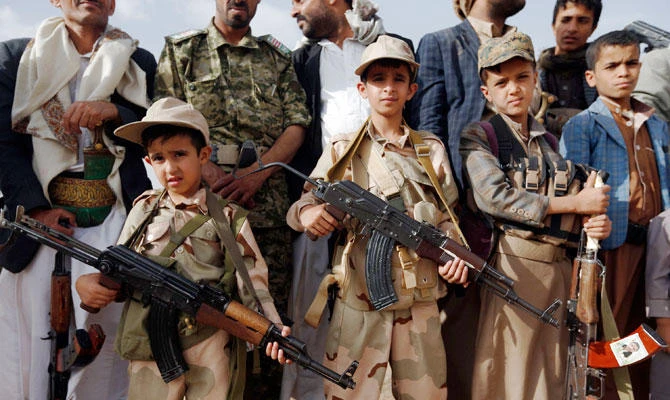 This file photo taken on June 18, 2017 shows Yemeni children carrying weapons as they take part in a gathering organised by Shiite Houthi rebels in the capital Sanaa. (AFP)