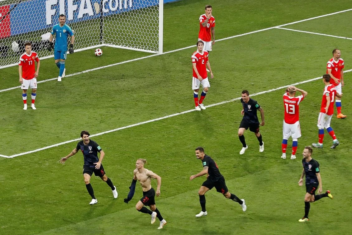 Croatia's defender Domagoj Vida (down, 2ndL) celebrates with teammates after scoring a goal during the Russia 2018 World Cup quarter-final football match between Russia and Croatia at the Fisht Stadium in Sochi on July 7, 2018. RESTRICTED TO EDITORIAL USE - NO MOBILE PUSH ALERTS/DOWNLOADS / AFP / Odd ANDERSEN / RESTRICTED TO EDITORIAL USE - NO MOBILE PUSH ALERTS/DOWNLOADS