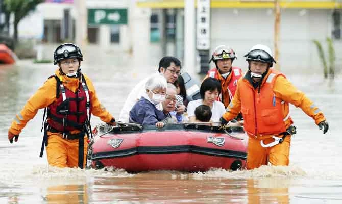 Local residents sit in a boat as they are rescued from a flooded area at a hospital in Kurashiki, Okayama Prefecture, Japan, in this photo taken by Kyodo July 8, 2018. (REUTERS)