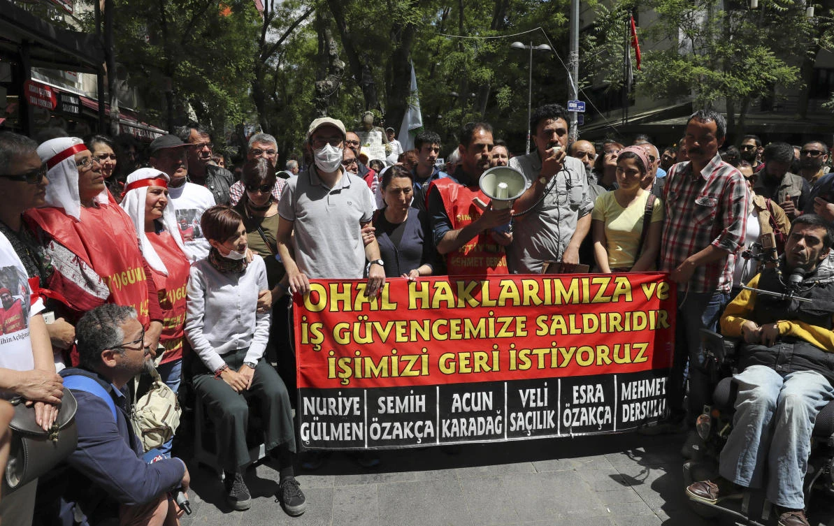 Former primary school teacher Semih Ozakca, fourth left, and Turkish academician Nuriye Gulmen, third left, during their 64th day of hunger strike on May 11, 2017, call on Turkish authorities to give back jobs to public employees who have been dismissed from their positions since the imposition of the state of emergency rule. (AFP)