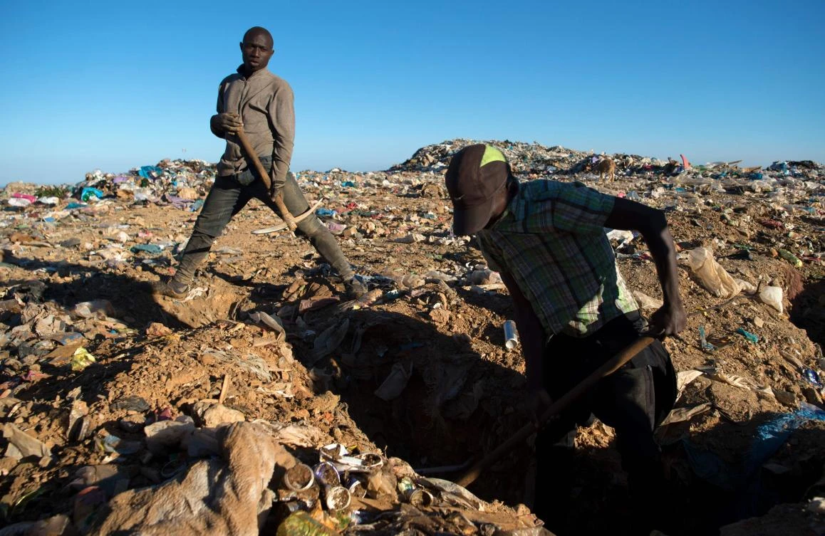 Migrants search for objects and food in a garbage dump in Fnideq, northern Morocco. (AFP)