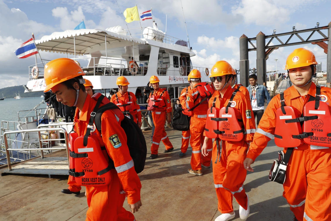 A Chinese rescue team arrives at Chalong pier in Phuket during the operation to retrieve fatalities of the double-decker Phoenix dive boat that sunk on Thursday. (AP)