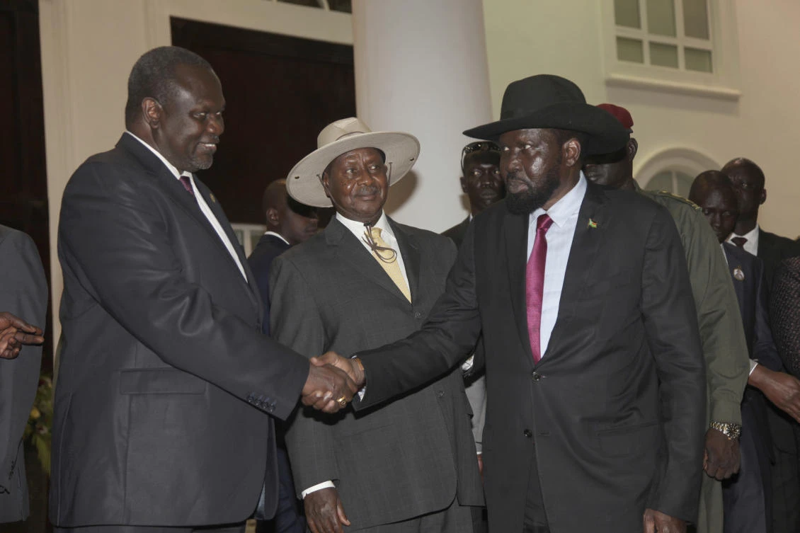 In this Saturday, July 7, 2018 photo, former Vice President of South Sudan Riek Machar, left, greets South Sudan President Salva Kiir as Uganda President Yoweri Museveni, center, looks on as they meet for a security meeting to find a lasting solution to insecurity in South Sudan, at the State House, in Entebbe, Uganda. (AP)