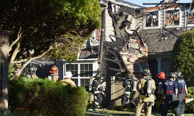 Authorities respond to an aviation crash at a residential structure, possibly involving a helicopter, on Sunday, July 8, 2018, in Williamsburg, Va. (AP)