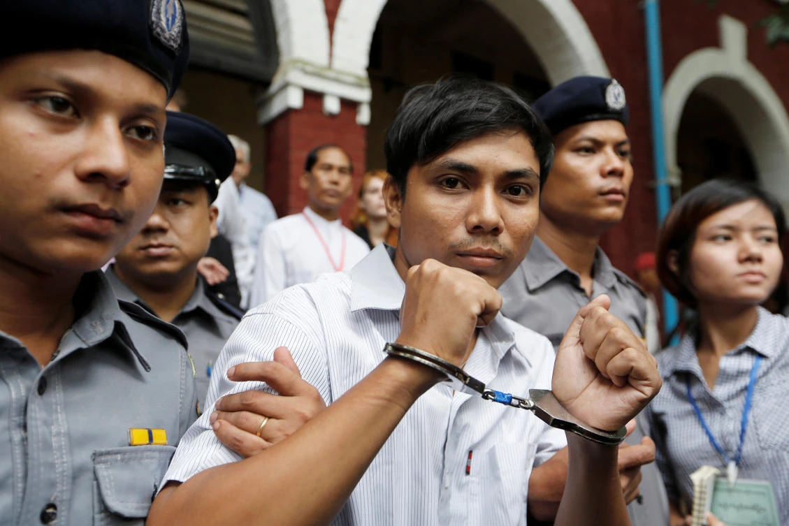 Kyaw Soe Oo, above, being escorted by police while leaving Insein court in Yangon on July 2, and Wa Lone pleaded not guilty of breaching the colonial-era Official Secret Act, which carries a maximum penalty of 14 years in prison. (Reuters)