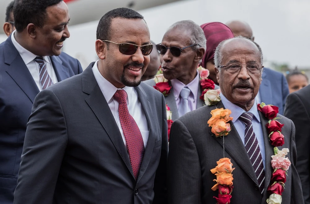 In this file photo taken on June 26, 2018 Eritrea’s Foreign Minister Osman Saleh Mohammed (R) walks with Ethiopia’s Prime Minister Abiy Ahmed (2L) and Ethiopia's foreign minister Workeneh Gebeyehu (L) as an Eritrean delegation for peace talks with Ethiopia arrives at the international airport in Addis Ababa. (AFP)