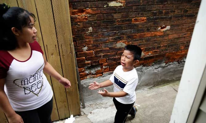 Carmelinda Perez tries to sooth her crying son, Franco, after he ran out of the house looking for his father in Florence, Ky., on April 28, 2018. (AP)