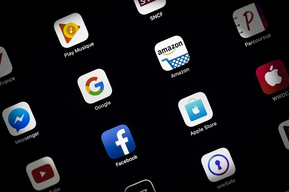 This illustration picture taken on April 19, 2018 in Paris shows the tablet and smartphone apps for Google, Amazon, Facebook and the Apple Store. (AFP)