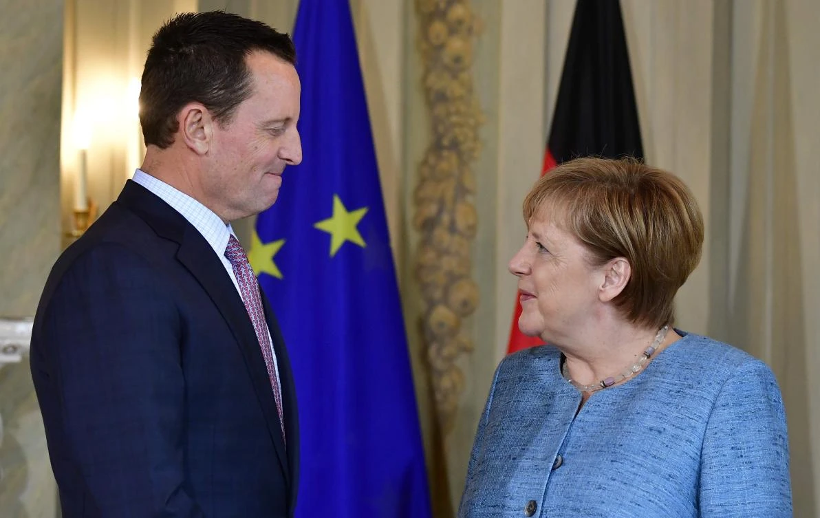 German Chancellor Angela Merkel chats with US ambassador to Germany Richard Grenell during a reception of the diplomatic corps at the German governmental guest house in Meseberg on July 6, 2018. (AFP)