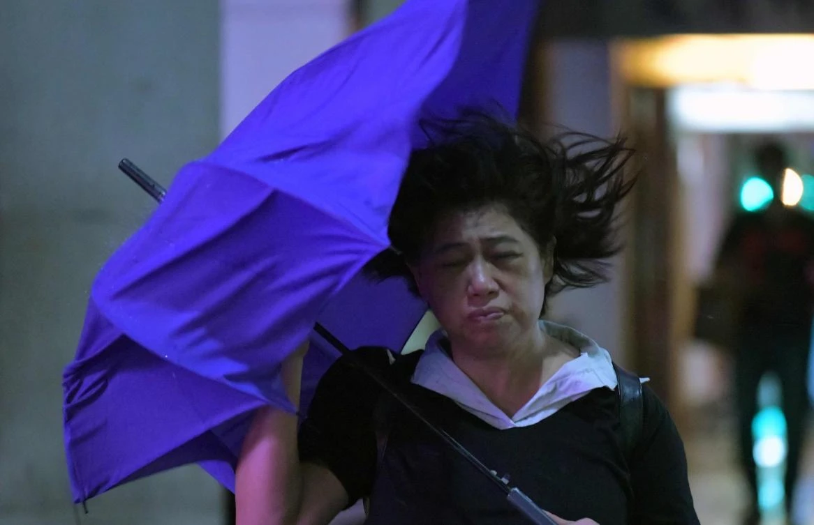 A woman walks through heavy wind and rain in Keelung on July 10, 2018 as Typhoon Maria moved toward Taiwan. (AFP)