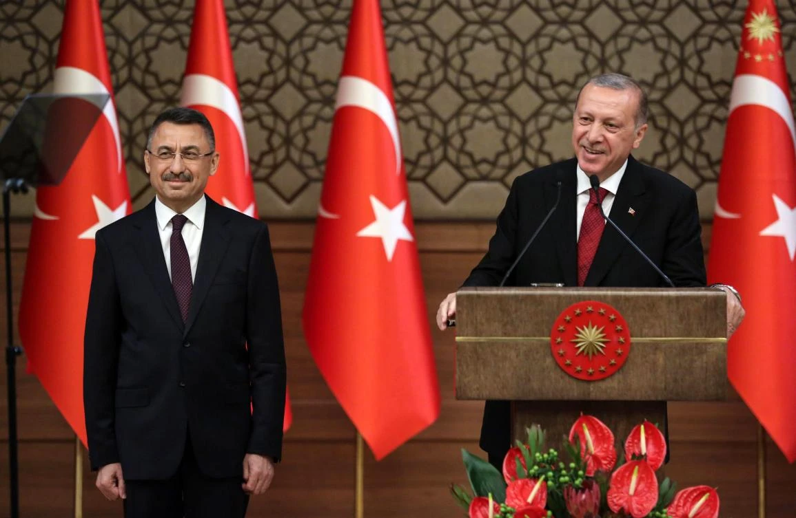 Turkey's President Recep Tayyip Erdogan (R) presents Turkey's new Vice President Fuat Oktay (L) during a news conference at the Presidential Palace in Ankara, on July 9, 2018. (AFP/ADEM ALTAN)