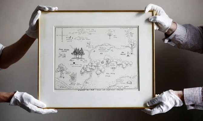 Sotheby's staff hold the original map of Winnie the Pooh's Hundred Acre Wood by E.H. Shepard at Sotheby's auction rooms in London, Britain, in this May 31, 2018 photo. (REUTERS)