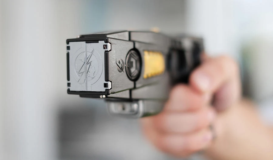 Closeup view of a loaded stun gun in a hand of a young man. (Shutterstock photo)