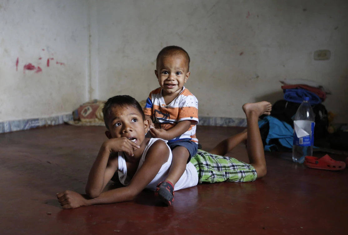 In this June 27, 2018 photo, Venezuelan migrant children play on the floor of the unfurnished home their parents are renting and sharing for the last two years with another Venezuelan family in Cucuta, Colombia. (AP)