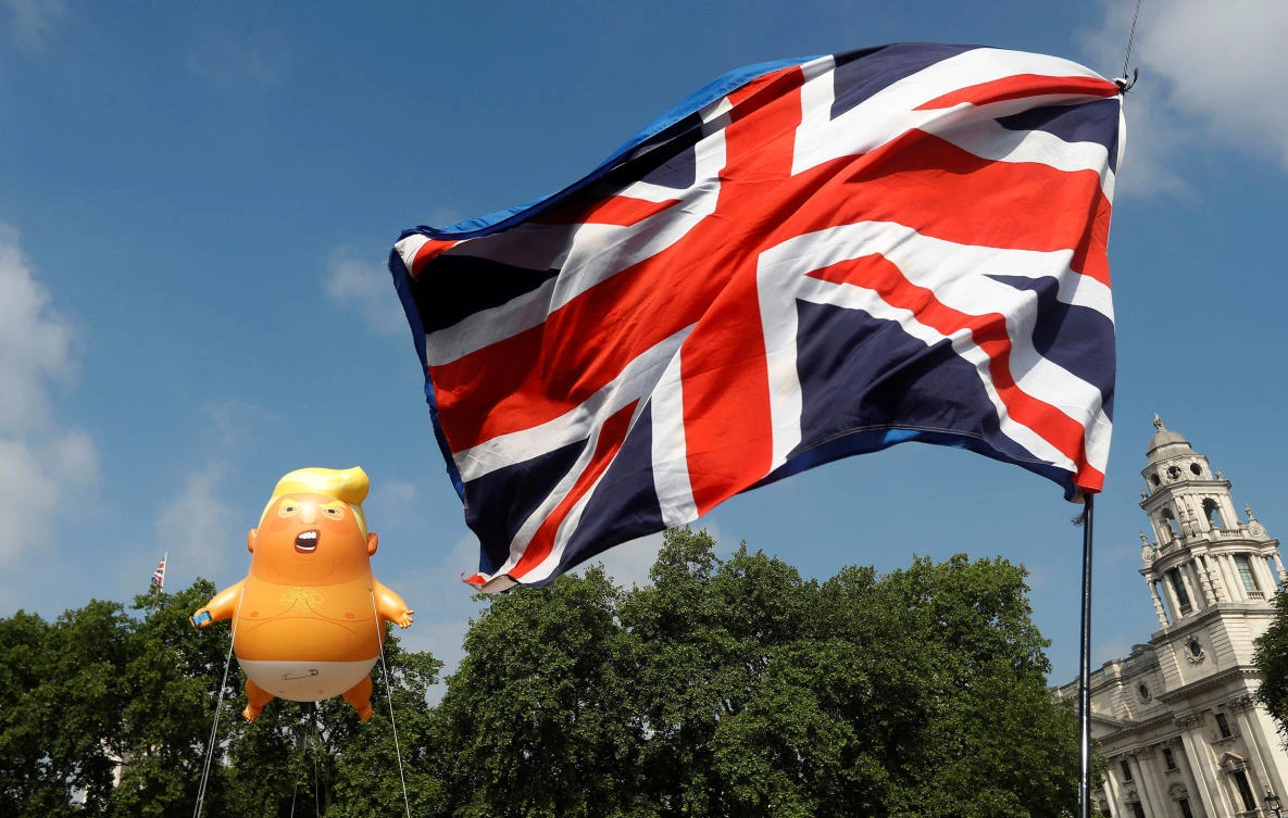 Demonstrators float a blimp portraying US President Donald Trump, next to a Union Flag above Parliament Square, during the visit by Trump and First Lady Melania Trump in London on Friday, July 13. (Reuters)