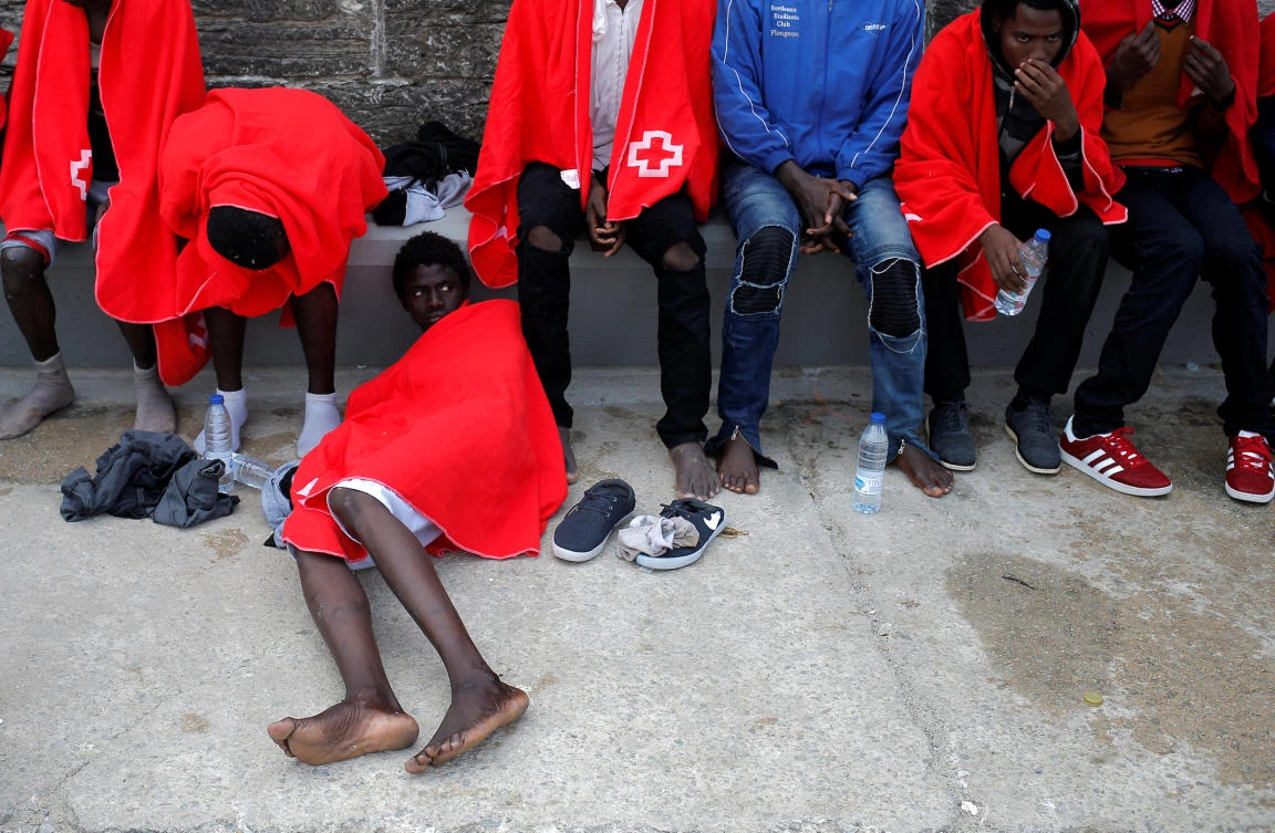Migrants intercepted aboard a dinghies off the coast in the Strait of Gibraltar, are seen after arriving on a rescue boat at the port of Tarifa, southern Spain July 13, 2018. (REUTERS)