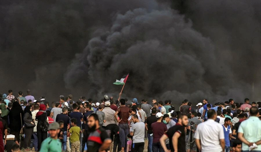 Smoke from a tire fire rises as Palestinians protest near the border with Israel east Gaza City on July 13, 2018 against the expropriation of Palestinian land by Israel. (AFP/Mahmud Hams)