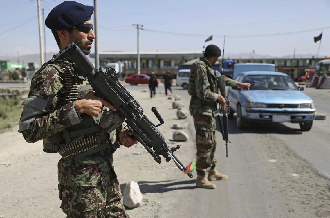 In this Tuesday, July 10, 2018 photo, an Afghan national army soldier stops a car at a temporary checkpoint on the outskirts of Kabul, Afghanistan. (Rahmat Gul/AP)