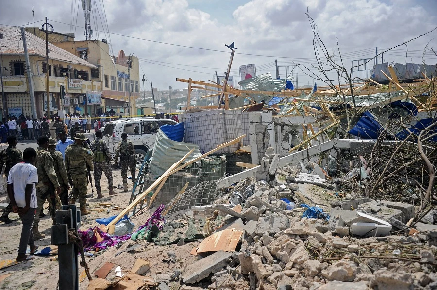 Somali security force personnel walk among debris at the site of a car bomb explosion near the building of the Interior Ministry in Mogadishu on July 7, 2018. Two explosions have rocked Somalia's internal security ministry in the capital Mogadishu, killing five civilians, a police officer said, in the latest attack claimed by Shabaab militants. (File Photo: AFP / Mohamed Abdiwahab)