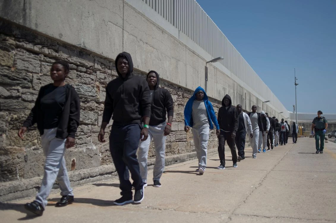 Migrants are transfered after arriving aboard a coast guard boat at Tarifa’s harbor on July 14, 2018. (AFP)