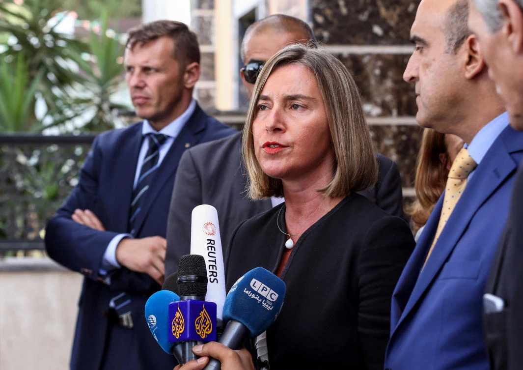 Federica Mogherini (C), European High Representative of the Union for Foreign Affairs and Security Policy, speaks to the press before her departure from Mitiga International Airport, about 8 kilometers east of the capital Tripoli, on July 14, 2018. (AFP)