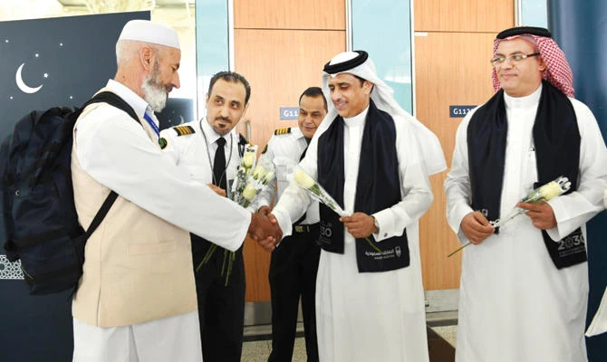 Saudi officials receive the first batch of Hajj pilgrims on Saturday in Jeddah. SPA
