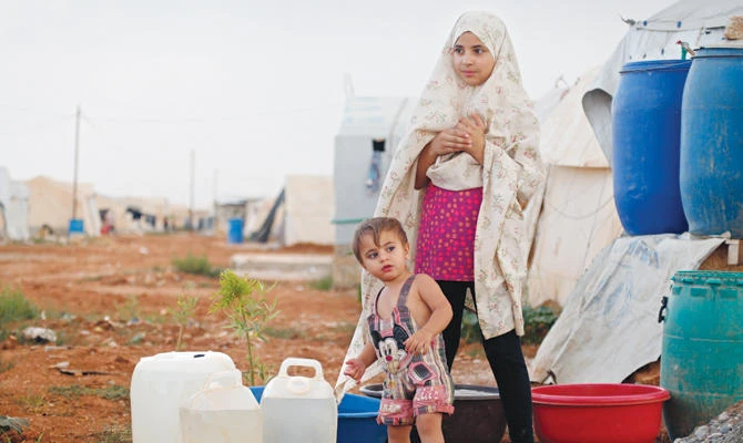 Syrians play outside the family tent at a camp for internally displaced people on the outskirts of Jarablus, northern Syria. AP