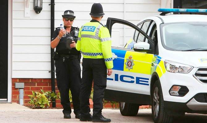 In this file photo taken on July 4, 2018 A police officer stands guard outside Charlie Rowley's house in Amesbury, southern England, on July 4, 2018 where police reported a man and woman were found unconscious in circumstances that sparked a major incident. (AFP)