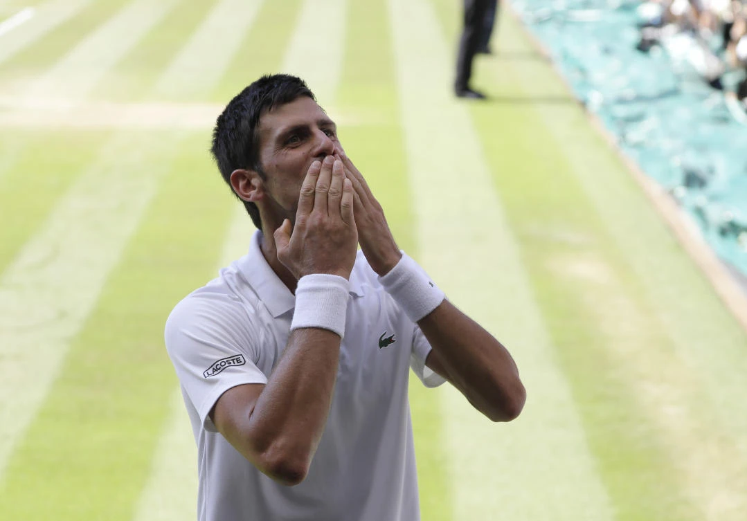 Serbia's Novak Djokovic celebrates winning the men's singles final match against Kevin Anderson of South Africa, at the Wimbledon Tennis Championships, in London, Sunday July 15, 2018. (AP Photo/Kirsty Wigglesworth)