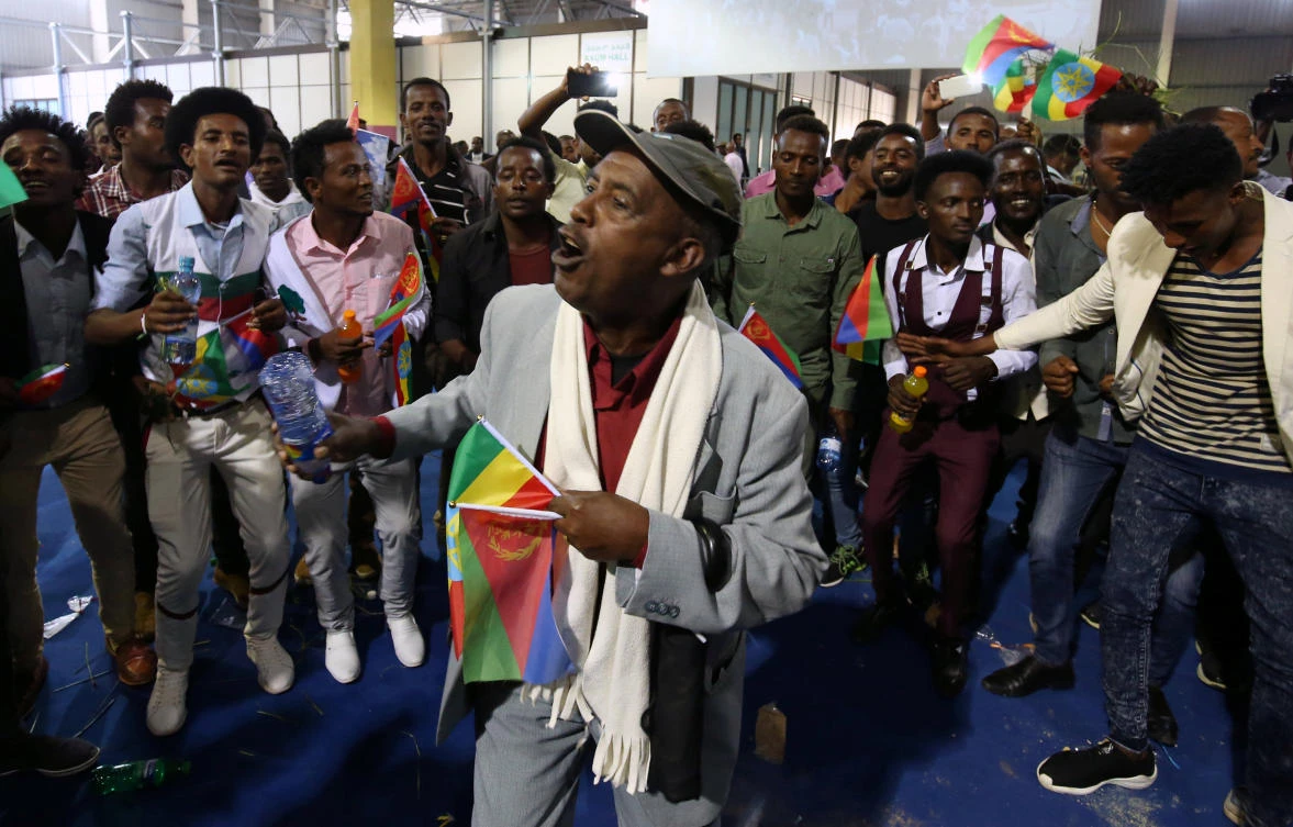 Residents carry the Ethiopian and Eritrean national flags as they dance during a concert at the Millennium Hall in Addis Ababa, Ethiopia July 15, 2018. (Reuters)