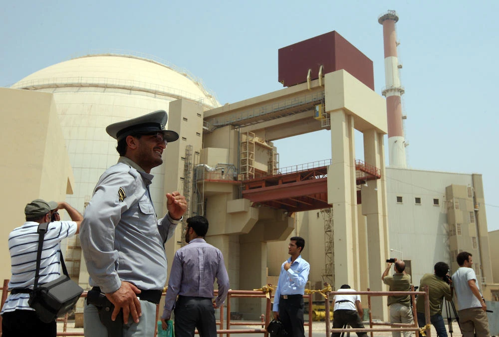 An Iranian security man stands next to journalists outside the reactor building at the Russian-built Bushehr nuclear power plant in southern Iran on August 21, 2010 during a ceremony initiating the transfer of Russia-supplied fuel to the facility after more than three decades of delay. (File photo AFP)