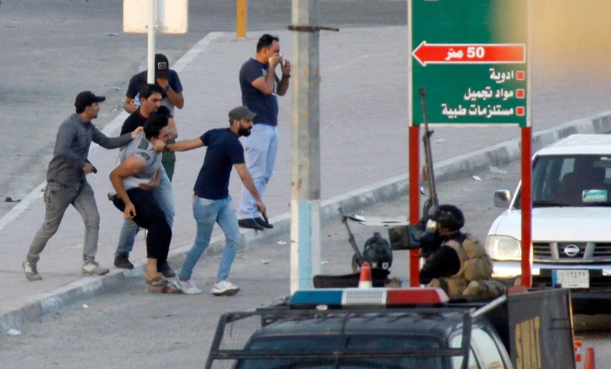 Above, members of the Iraqi security forces detain a protester on July 14 who took part in the week-long demonstrations to demand more jobs and better services. (AFP)