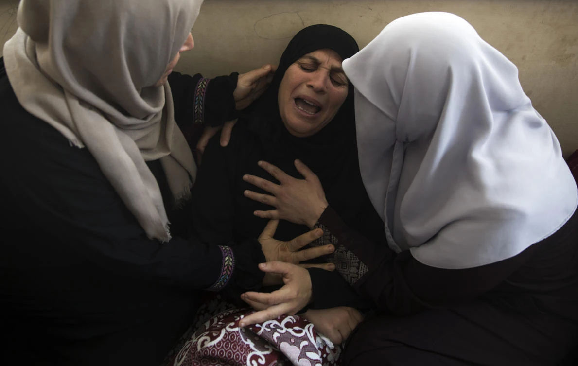 Relatives of 15-year-old Othman Hilles, mourn during his funeral in the family home in Gaza City, Saturday, July 14, 2018. (File Photo: Khalil Hamra/AP)