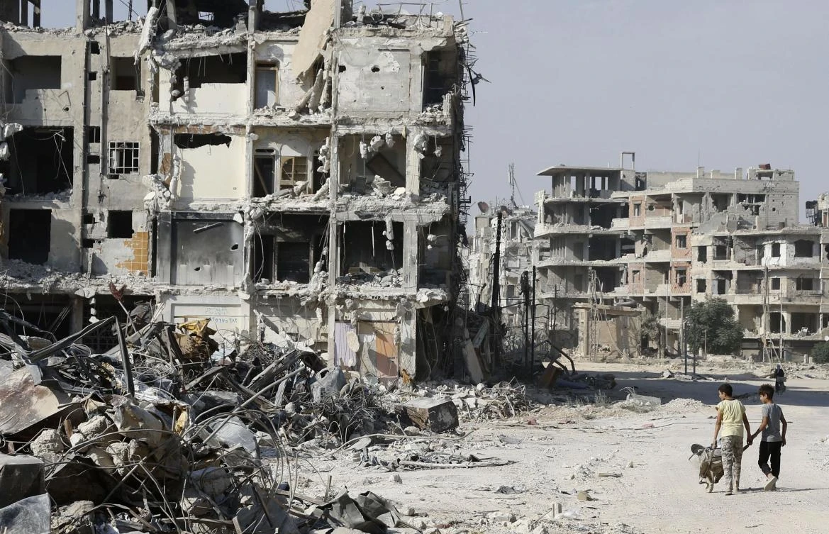 Gutted Syrian town begins modest reconstruction, street by street