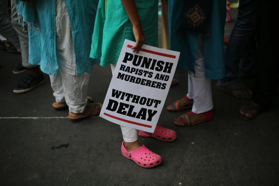 A protester stands with a placard during a protest against rape near the Indian parliament in New Delhi on April 2018. (AP)