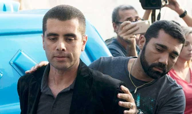 Brazilian "celebrity" surgeon Dr. Denis Cesar Barros Furtado is escorted by police after his arrest in Rio de Janeiro, Brazil, on Thursday. (AP)