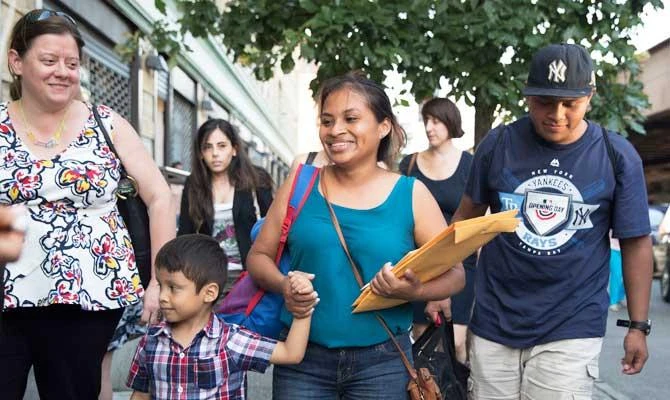 Julie Schwietert-Collazo, left, of Immigrant Families Together, walks with Rosayra Pablo Cruz, center, as she leaves the Cayuga Center with her sons 5-year-old Fernando, second from left, and 15-year-old Jordy, in this July 13, 2018 photo, in New York. (AP)