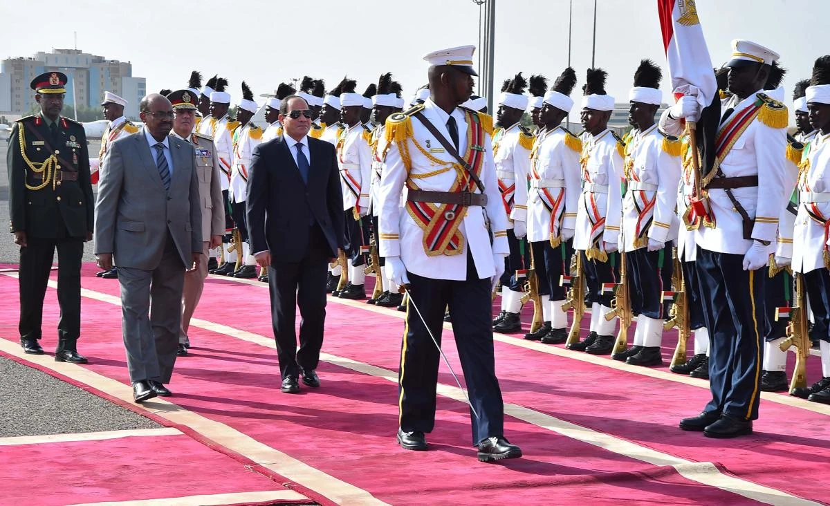 A handout picture made available on July 19, 2018 by the Egyptian presidency shows Sudanese President Omar Al-Bashir (2nd L) receiving his Egyptian counterpart Abdel Fattah El-Sisi (C) upon his arrival at Khartoum airport in the Sudanese capital. (AFP)