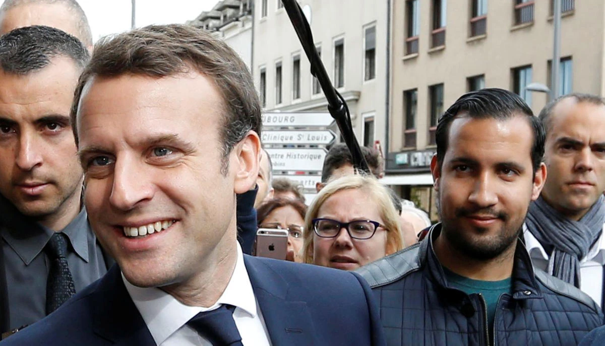 Macron fires bodyguard filmed beating protester; critics say too late