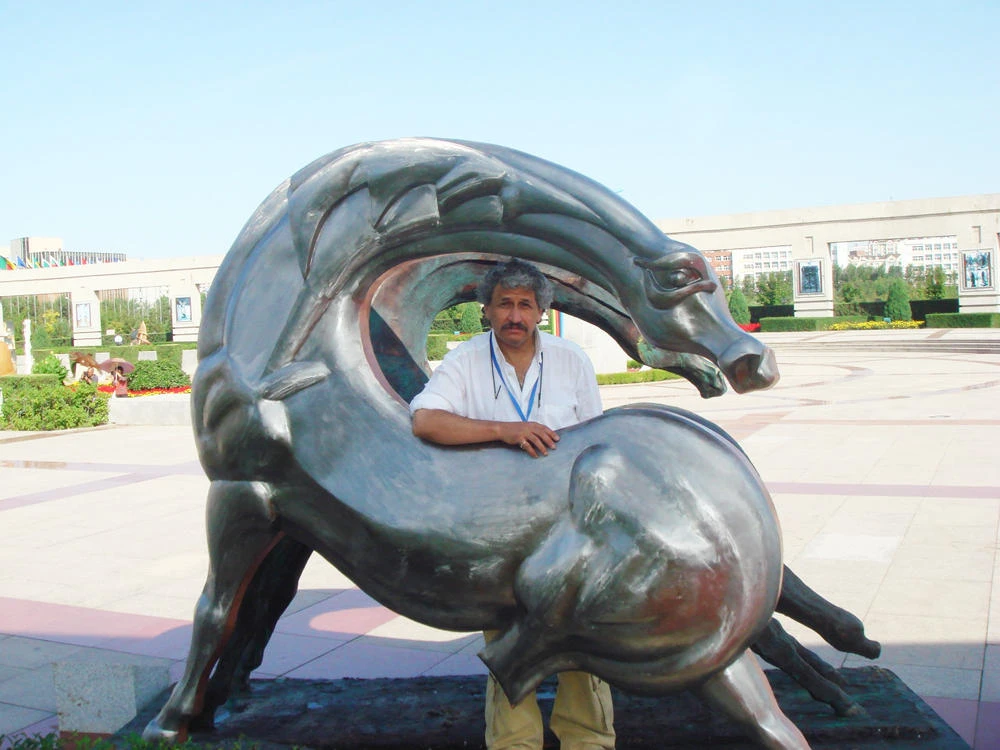 Kamal Al-Mualem with his sculptural works carried out in China.