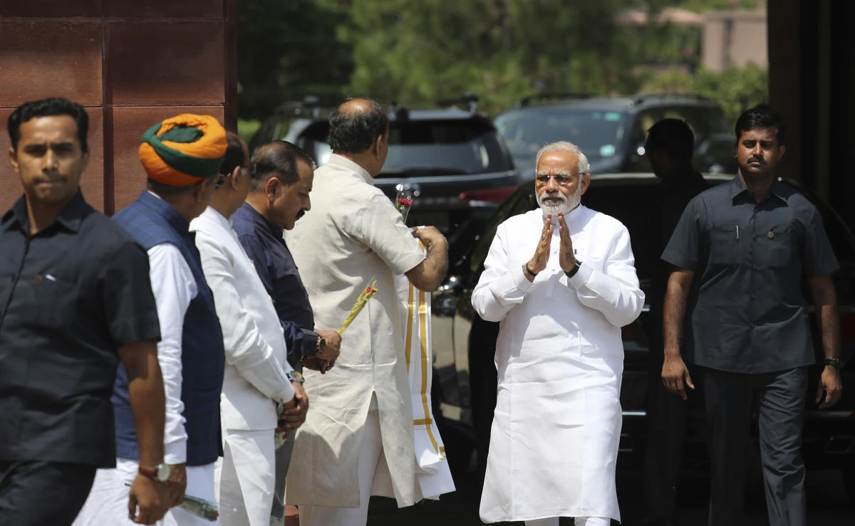 Narendra Modi sailed through a confidence vote in a theatrical parliamentary session which saw a startled prime Minister Narendra Modi embraced by his chief political foe Rahul Gandhi. (AP Photo)