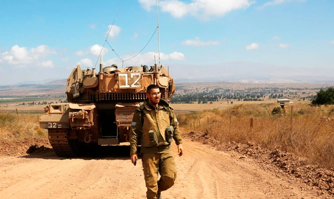 A photo taken on July 20, 2018 in the Israeli-annexed Golan Heights shows an Israeli Merkava tank patrolling on the border between Israel and Syria. (AFP)