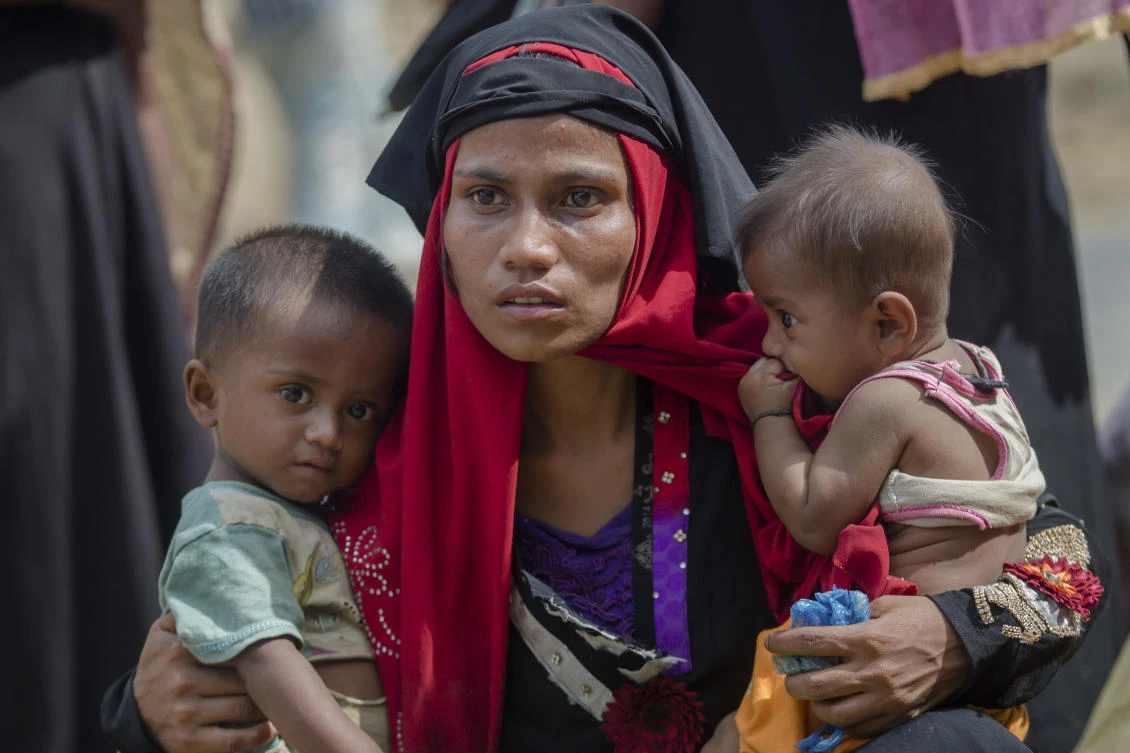 Rohingya Muslim woman, Rukaya Begum, who crossed over from Myanmar into Bangladesh, holds her son Mahbubur Rehman, left and her daughter Rehana Bibi, after the government moved them to newly allocated refugee camp areas, near Kutupalong, Bangladesh. (File Photo: Dar Yasin/AP)
