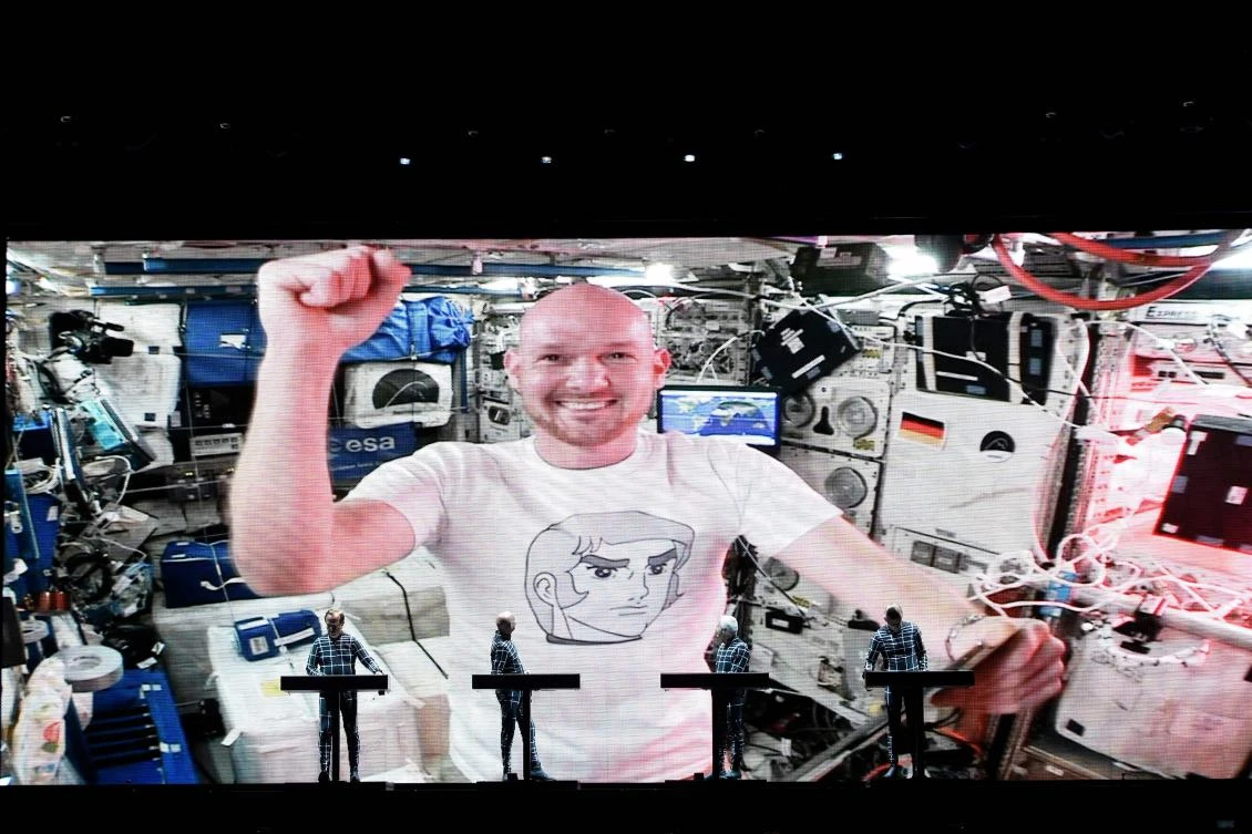 German ISS astronaut Alexander Gerst is seen on a video screen during a concert of the electric band 'Kraftwerk' at the Schlossplatz in Stuttgart, southern Germany on July 20, 2018. (AFP/Reiner PFISTERER)