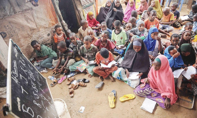 Displaced Somali children and teenagers attend a class to learn alphabets and numbers at a makeshift school at the Badbado IDP camp in Mogadishu. (AFP)