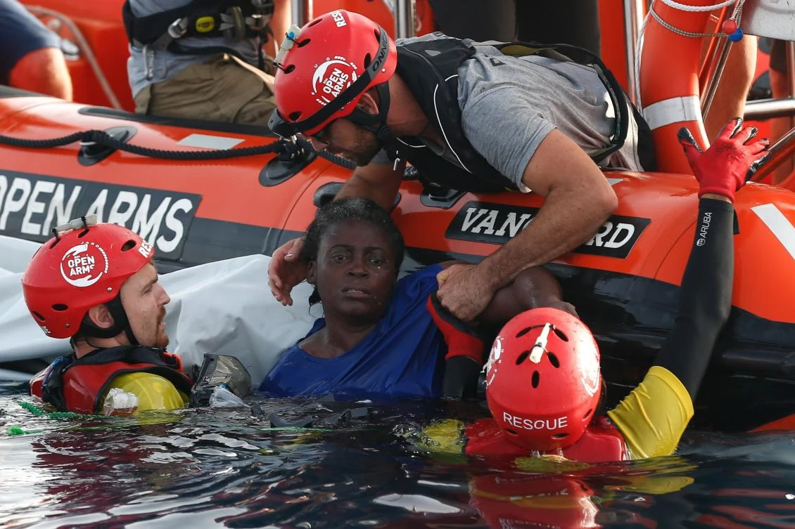 Members of the Spanish NGO Proactiva Open Arms rescue a woman in the Mediterranean open sea about 85 miles of the Libyan coast on July 17, 2018. (File Photo: Pau Barrena/AFP)